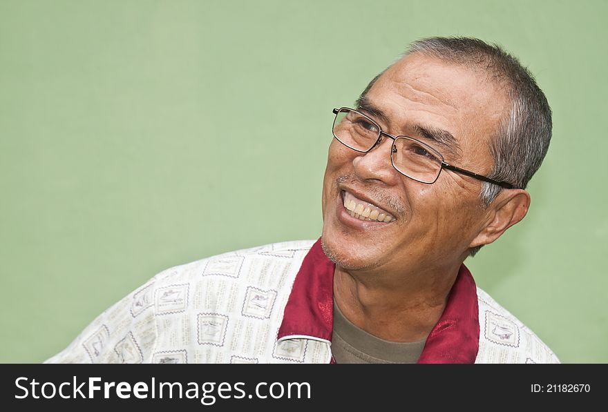 Laughing old man in green