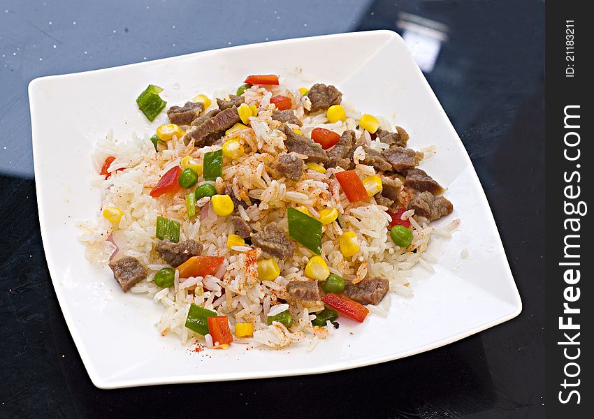 Beef, peas fried rice on a plate