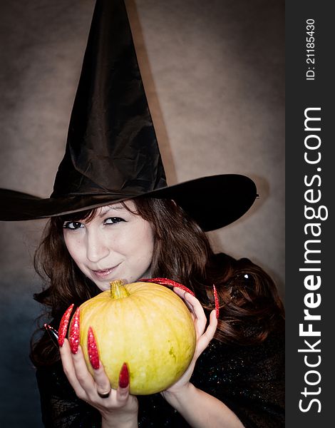 Witch with pumpkin in hands