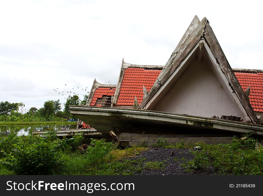 Ruins of the thai house has red roof broken down which is located pond side. Ruins of the thai house has red roof broken down which is located pond side.