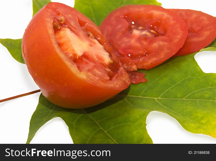Red tomatoes on green leaf as ingredient of salad. Red tomatoes on green leaf as ingredient of salad