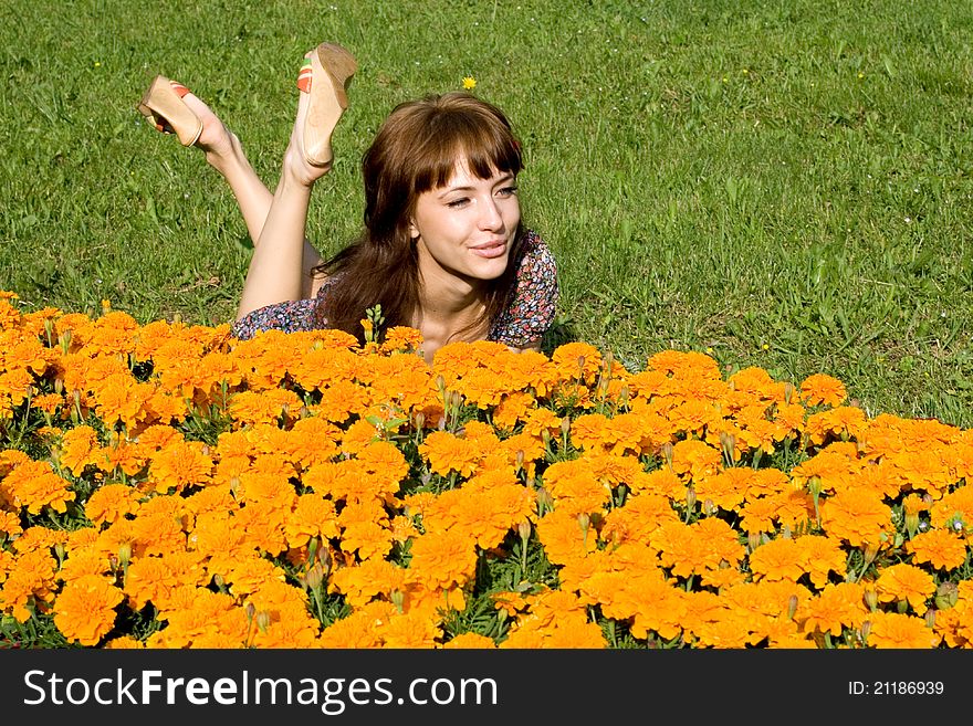 Beautiful girl lying on meadow with flowers