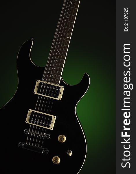 Black Electric Guitar On Green