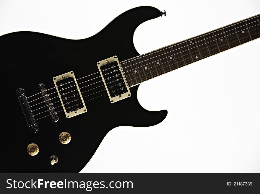 A black electric guitar isolated against a white background. A black electric guitar isolated against a white background