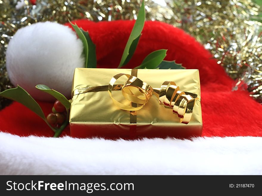 Image of a christmas present placed on a santa hat