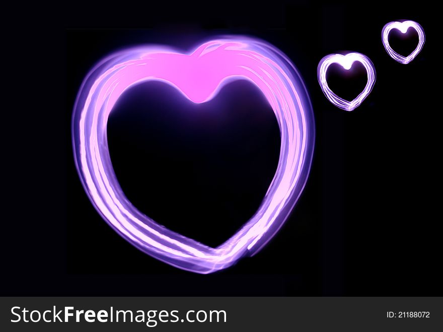 Image pink heart glow in the darkness