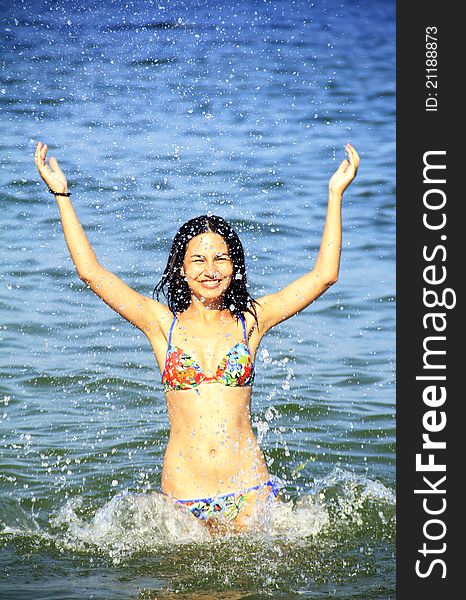 Young girl with black hair enjoys swimming. Young girl with black hair enjoys swimming