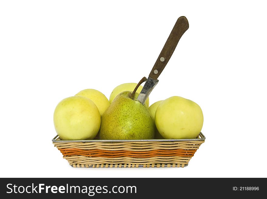 A red apple stabbed with a knife, surrounded by pears. A red apple stabbed with a knife, surrounded by pears