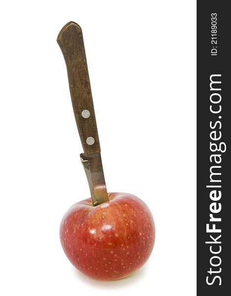 Knife in the apple on a white background