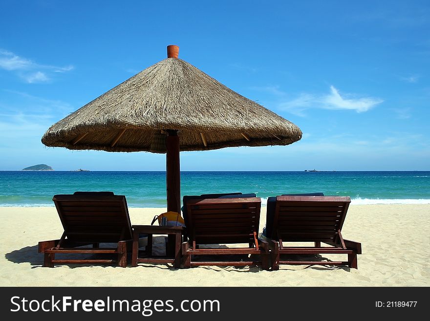 Beautifu beach with chairs and sun  umbrella