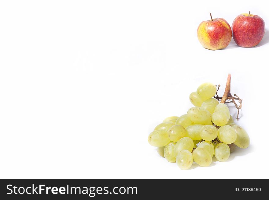 Apples and grapes on a white background. Apples and grapes on a white background