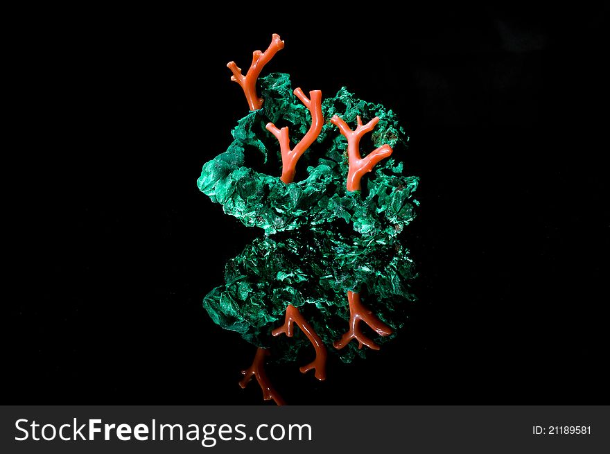 Malachite and coral jewerly compozition on black background