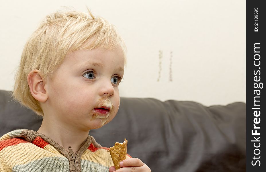 Cute blond toddler boy enjoying an ice cream. Cute blond toddler boy enjoying an ice cream