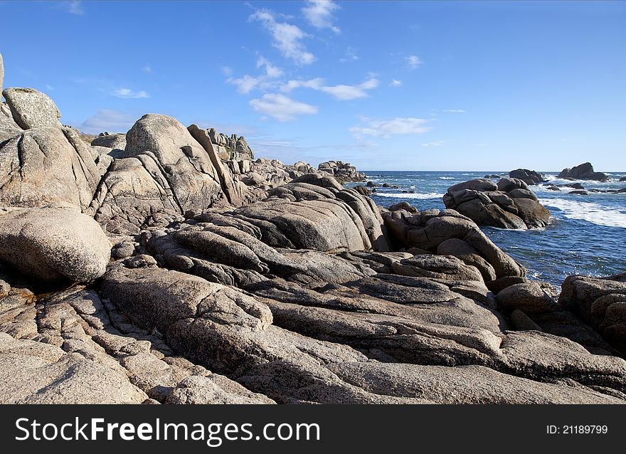 Ocean stone coast and blue sky in Galicia