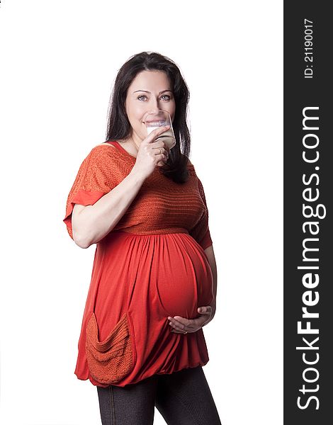 A pregnant woman drinks milk isolated on white