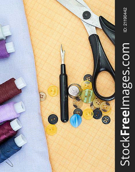 Sewing supplies: thread, scissors, buttons