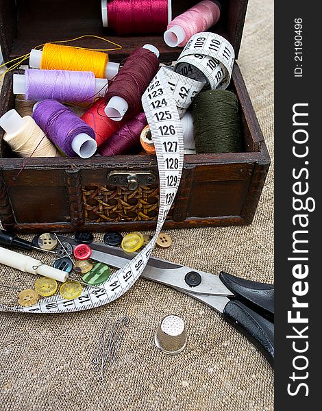 Different sewing supplies: thread, scissors, buttons