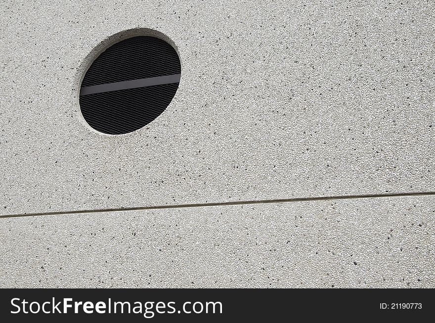 Textured urban wall with a circle and a line in exterior scene. Textured urban wall with a circle and a line in exterior scene