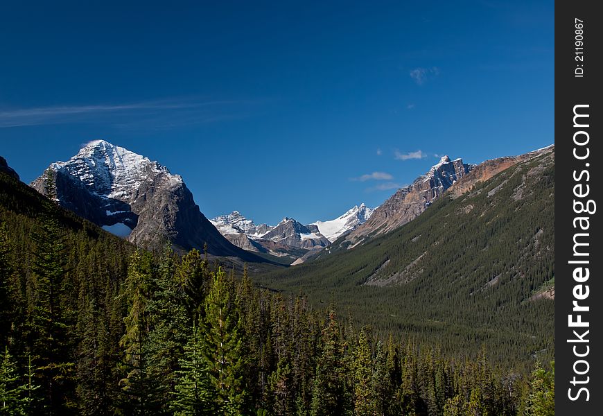 Mountains towering over a deep valley. Mountains towering over a deep valley.