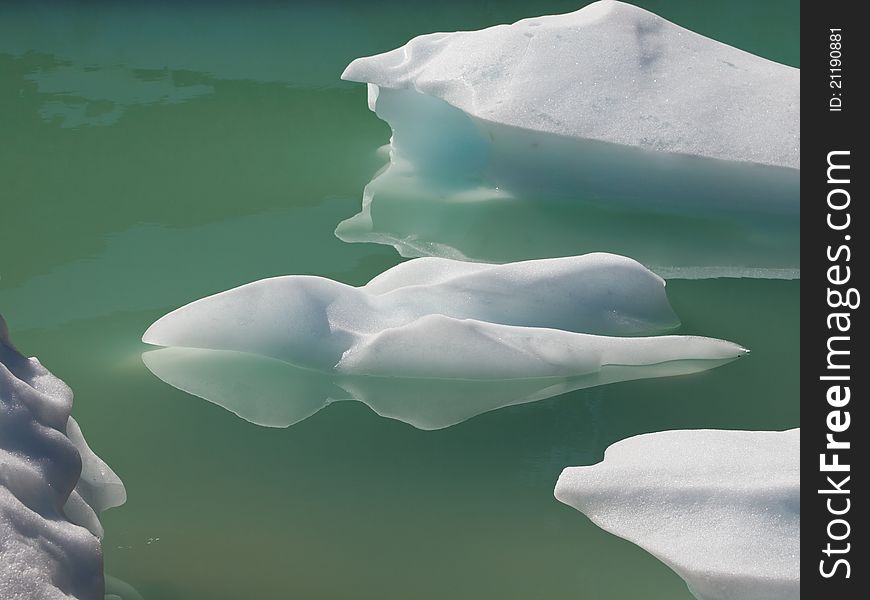 Pieces of ice floating in frigid glacial waters. Pieces of ice floating in frigid glacial waters.