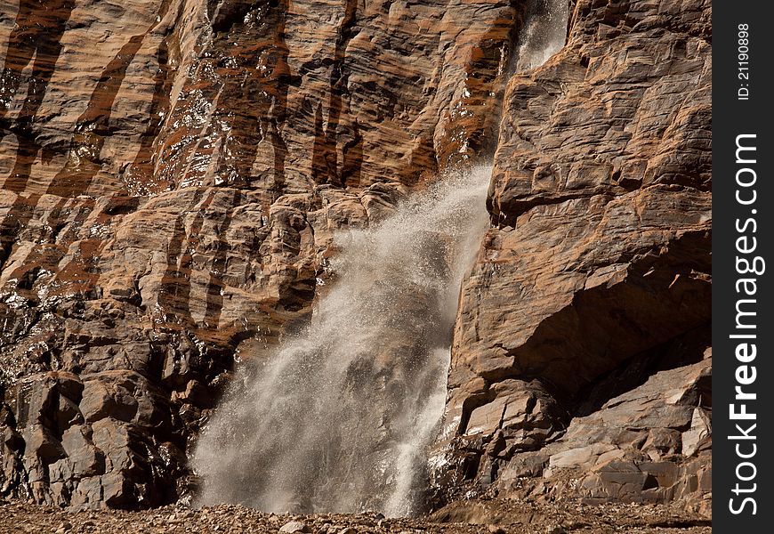 Waterfall coming out of a rock face. Waterfall coming out of a rock face.