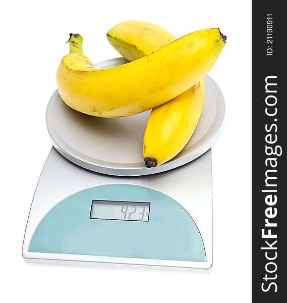 Bananas on the scales on a white background