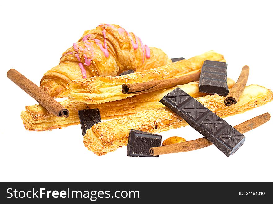 Crispy sticks with sesame and croissant on white background