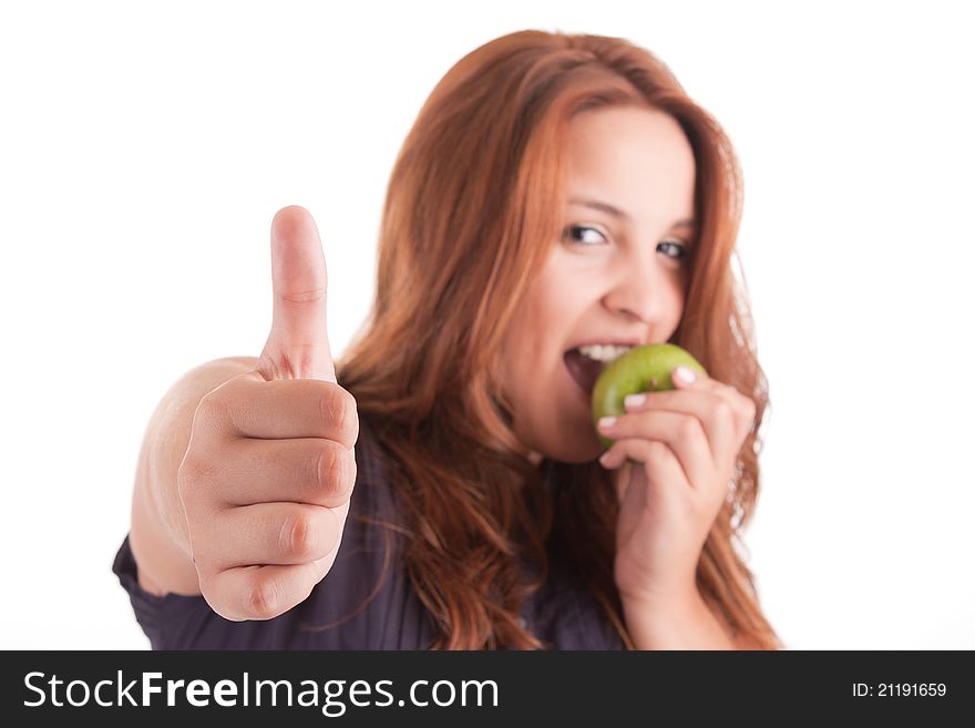 Young woman with green apple and showing thumb up