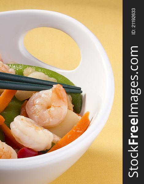 Asian salad in a white bowl with green chopsticks. Asian salad in a white bowl with green chopsticks.