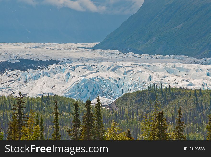 Closeup shot of majestic glacier stretching over mountain valley displaying the forces of nature. Closeup shot of majestic glacier stretching over mountain valley displaying the forces of nature.