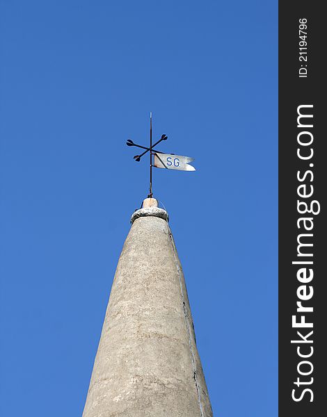 Stone church tower and the weather vane