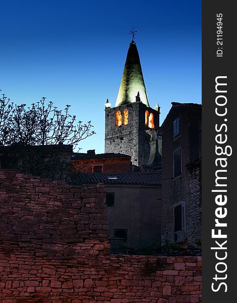 The church tower and the stonewall at dusk