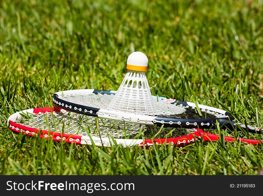 Two badminton rackets and shuttlecock closeup