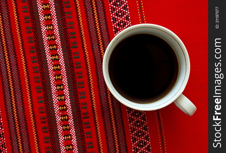 A cup of coffee on the red background. A cup of coffee on the red background.