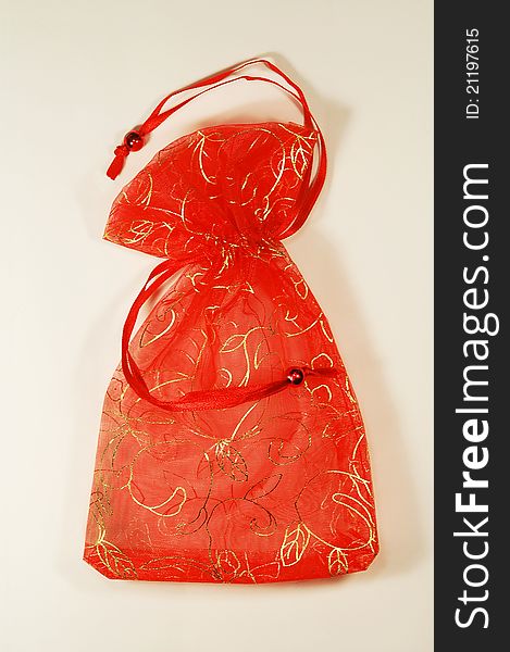 Small shiny red present bag with a rope. Small shiny red present bag with a rope