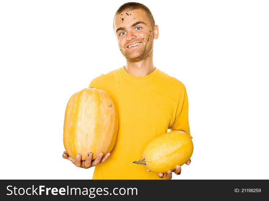 Handsome young man holds a lot of different pumpkin in his hands. Lots of copyspace and room for text on this isolate. Handsome young man holds a lot of different pumpkin in his hands. Lots of copyspace and room for text on this isolate