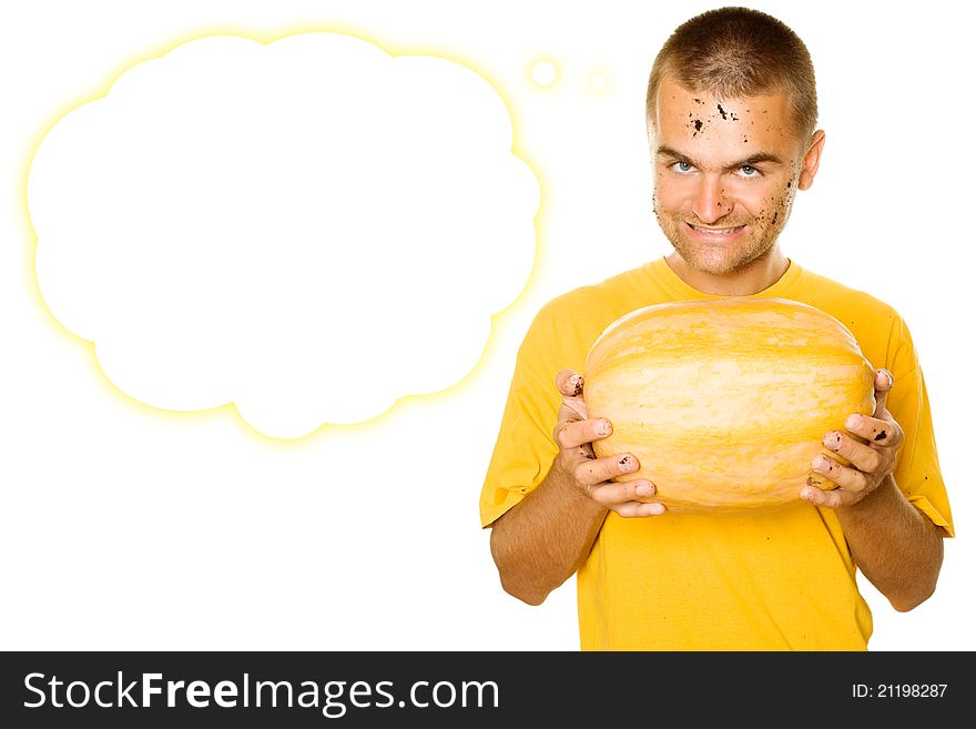 Young man squeezes with both hands a pumpkin face and hands stained the ground. Approximation of Halloween. Isolated on a white background. Young man squeezes with both hands a pumpkin face and hands stained the ground. Approximation of Halloween. Isolated on a white background