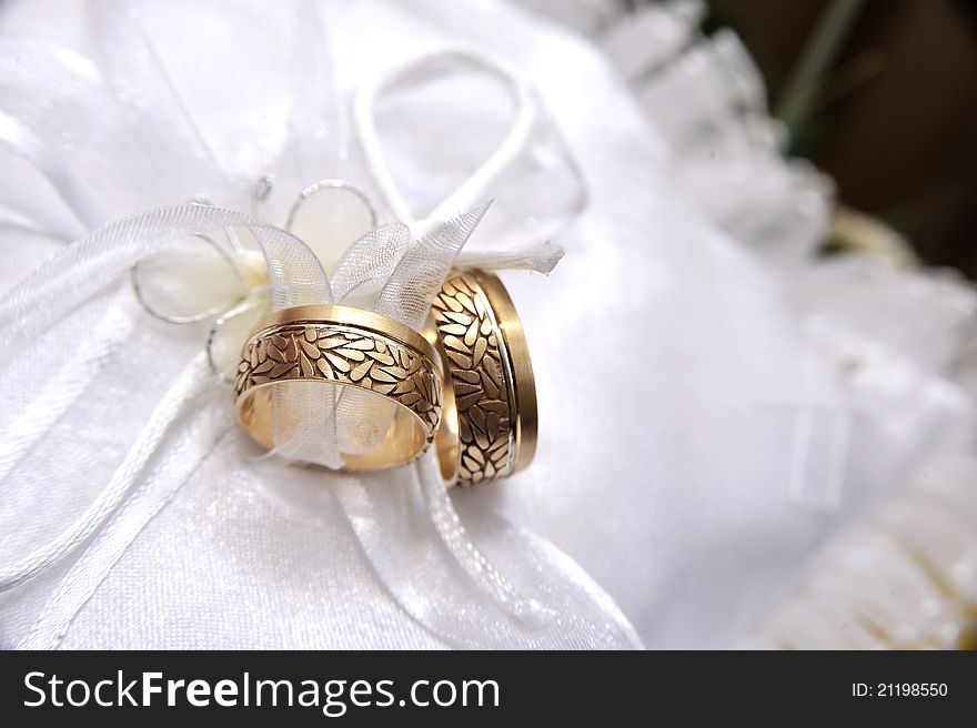Two gold wedding rings on a pillow. Two gold wedding rings on a pillow