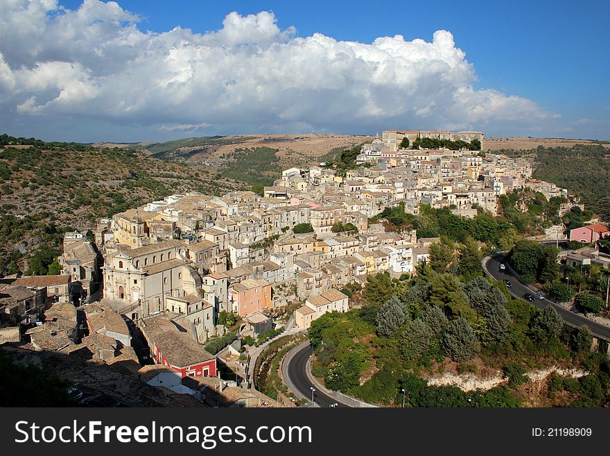 Ragusa Ibla against a backdrop of blue sky and clouds in Sicily taken from the roads leading up to Ragusa Superiore. Ragusa Ibla against a backdrop of blue sky and clouds in Sicily taken from the roads leading up to Ragusa Superiore