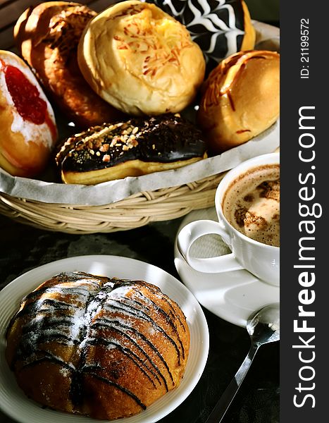 Delicious bread sweetened with multi flavour taste served in the background and Chocolate bread as the main focus. Great images for food and beverages article or any design involving food and drinks. Delicious bread sweetened with multi flavour taste served in the background and Chocolate bread as the main focus. Great images for food and beverages article or any design involving food and drinks.