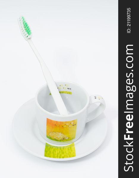 Toothbrush and cup on white