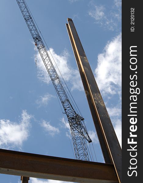 Construction crane and steel girders against blue sky. Construction crane and steel girders against blue sky