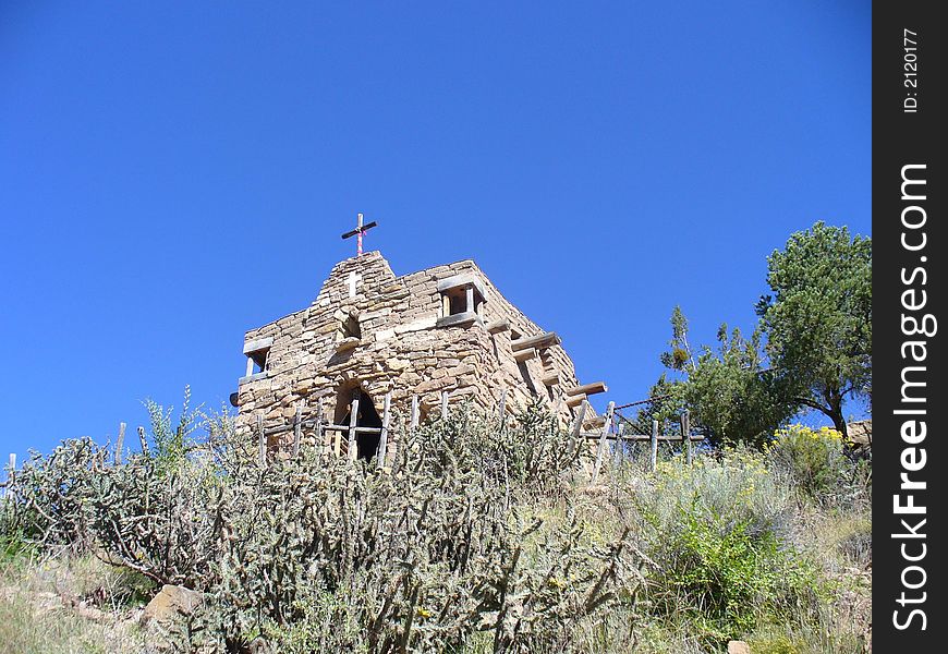 A small stone chapel  on a hill, on a beautiful clear day. A small stone chapel  on a hill, on a beautiful clear day