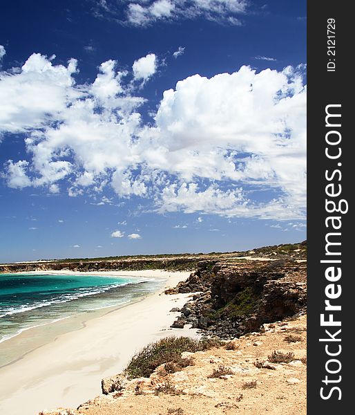 Seascape, with dramatic blue sky and white clouds, vertical. York Peninsula, South Australia.