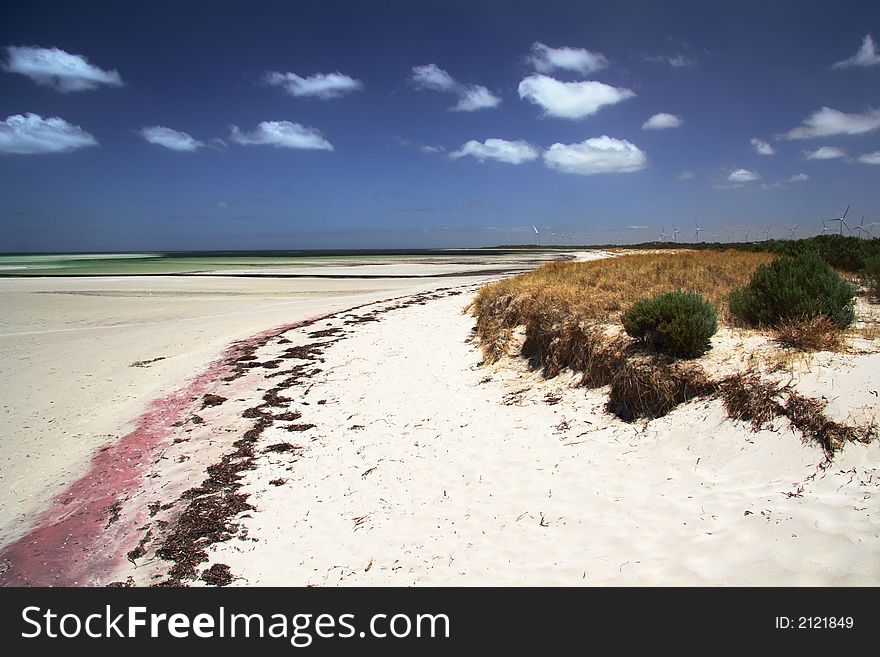 Beautiful beach with colorful sand, blue sky and white clouds. York Peninsula, South Australia. Beautiful beach with colorful sand, blue sky and white clouds. York Peninsula, South Australia.