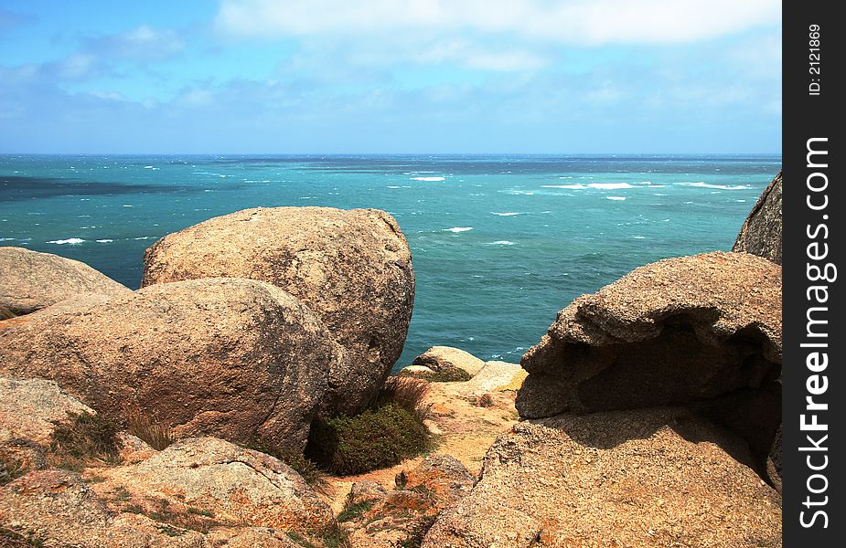 Seascape with rocks and cloudy sky. Granite Island, South Australia