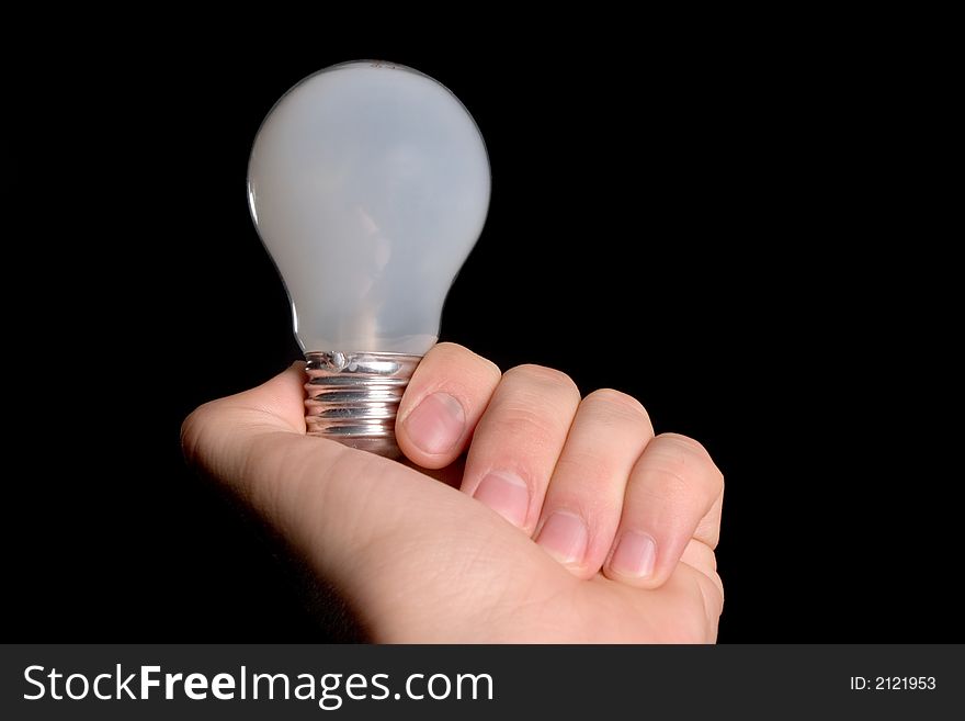 Mate bulb in hand isolated over black background. Mate bulb in hand isolated over black background