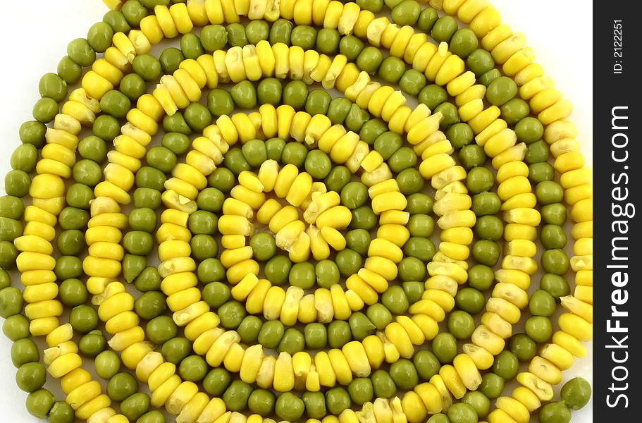 Close up at vegetable spiral made from corn and green peas. Close up at vegetable spiral made from corn and green peas