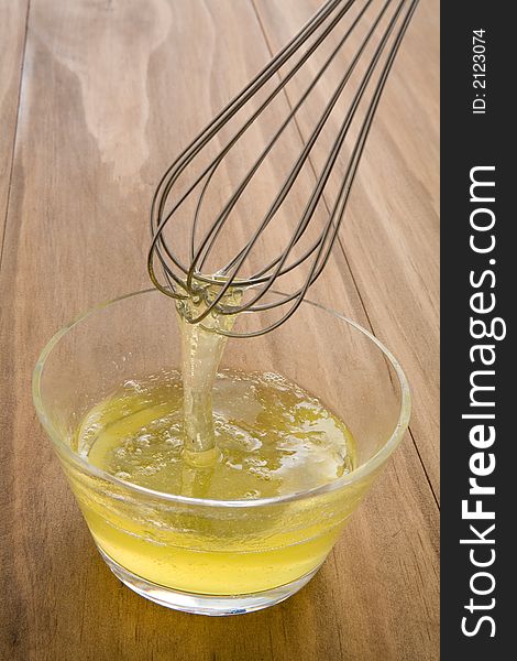 Whisking raw egg whites in a glass bowl