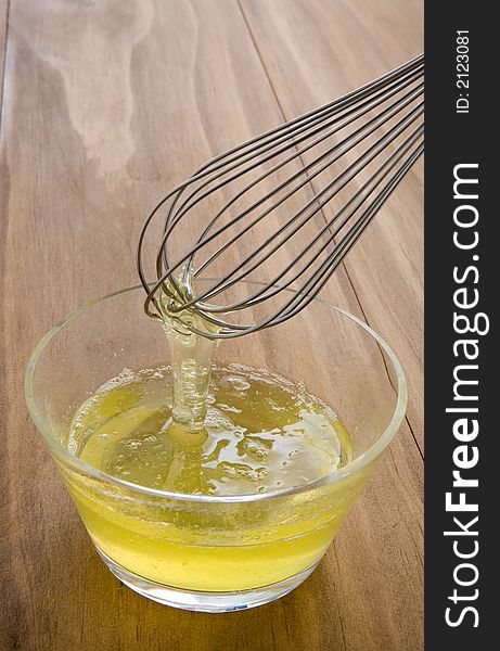 Whisking raw egg whites in a glass bowl